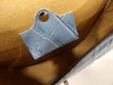 a close up of a purse with a tag on it
