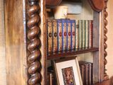 a wooden book shelf with many books on top of it