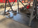 an image of a man working on a vehicle in a garage