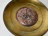 a gold plate with a flower design on it