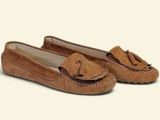 tan sued slippers with a bow on the front of them