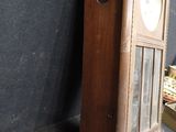 a wooden grandfather clock that is on display in a room