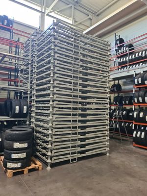 a large stack of tires sitting on top of a pallet in a warehouse