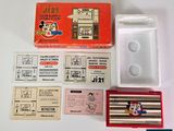 a box of pencils and a set of stamps on a table