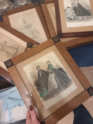 a person holding a picture of a woman in a dress
