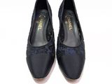 pair of women ' s black shoes on a white surface