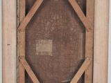an old picture of a wooden frame with a picture inside of it