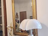 a dresser with a mirror and a lamp on top of it