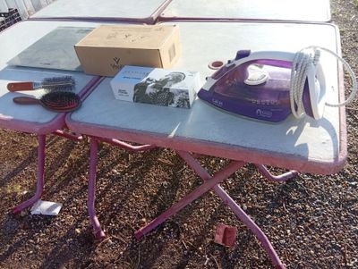 a table with an iron and a box on it
