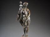 a bronze statue of a man holding a bird on a marble base