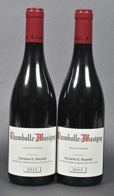 two bottles of red wine sitting next to each other on a table