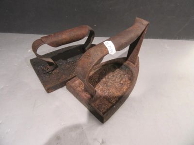 a pair of old iron tongs on a table