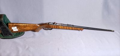 an old rifle with a wooden barrel and a leather case