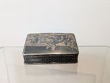 a silver box sitting on a glass table
