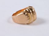 an image of a gold ring on a white surface