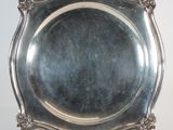 an antique silver plate on a stand on a white background