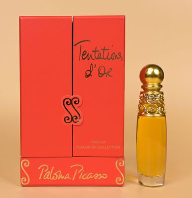 an orange box with a small bottle of perfume next to it