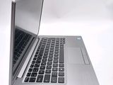 a silver laptop computer sitting on top of a white table