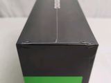 a black box with a green bottom on a table