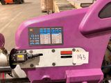 a purple machine that is sitting in a warehouse