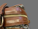 a close up of a purse with a belt on it
