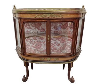 an antique display cabinet with a glass door and gold trimming
