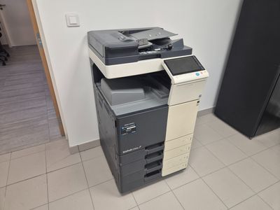 a multi - function printer sitting on the floor in a room