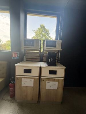 two microwaves and a couch in a room