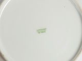a white plate with a green design on it