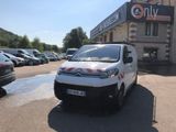 a small white van parked in front of a building