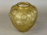 a yellow glass vase with a flower design on it