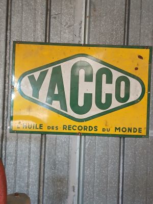 a yellow and green sign that says yacco on it