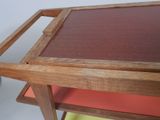 a wooden table with a glass top on a white background