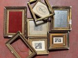 a lot of picture frames that are on the floor