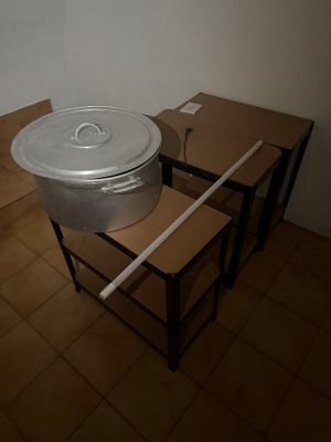 pots and pans are sitting on a table in a room