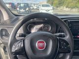 a steering wheel and dashboard of a car on the road