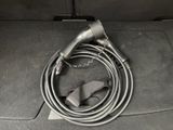 a cord connected to a charger in the back seat of a car
