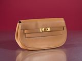 an image of a tan purse sitting on top of a table