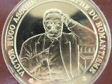 a silver coin with a picture of a man talking on the phone