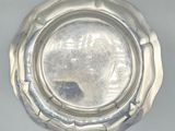 a silver plate that is sitting on a table
