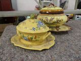 a yellow teapot and saucer sitting on top of a table