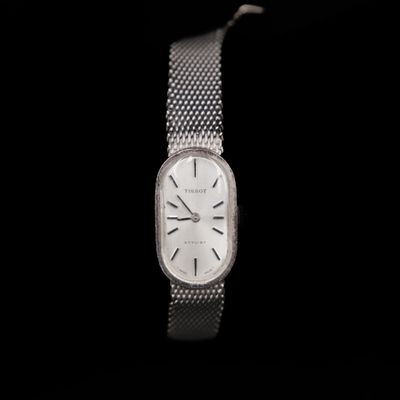 an image of a close up of a wrist watch on a black background