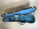 a blue case that has a guitar inside of it