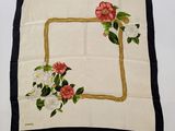 a close up of a white and black square with flowers on it