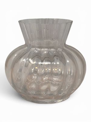 a clear glass vase that is sitting on a white surface