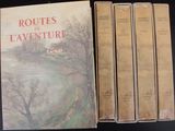 trois livres sont posés sur une table les uns à côté des autres
