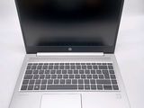 an open laptop computer sitting on top of a white table