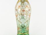 a glass vase with a floral design on it