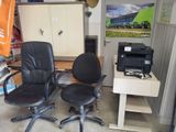two office chairs and a printer in a room