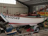 a boat that is sitting on a trailer in a garage